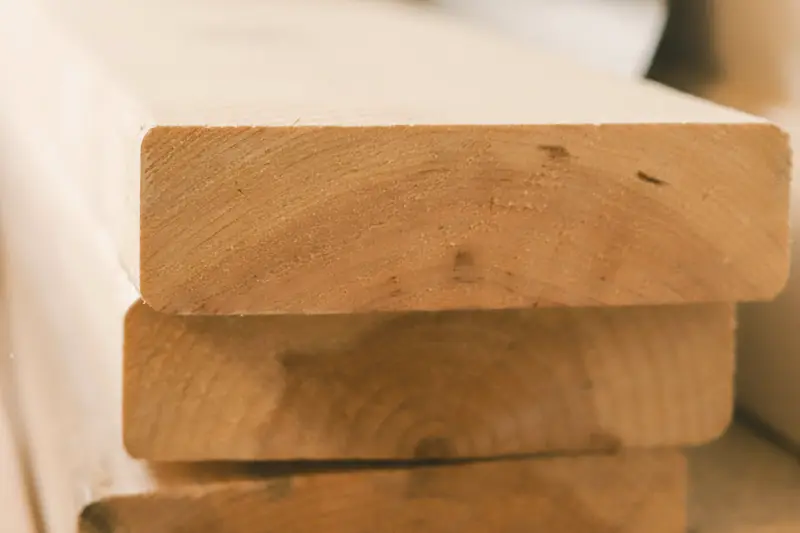 End grain of stacked 140 by 45 pine boards.